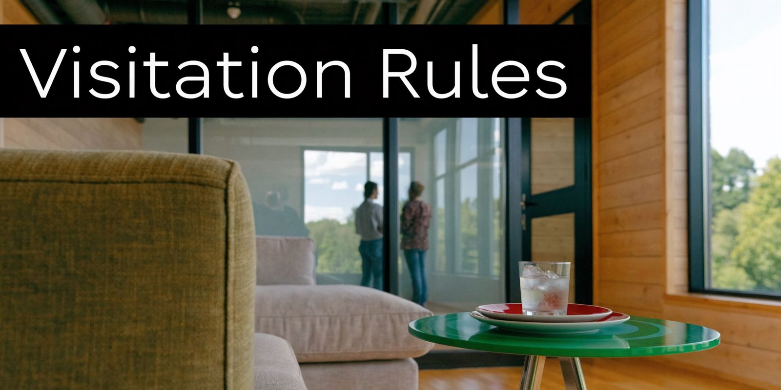 A view of a modern visitor waiting area with a comfortable couch and a small side table.