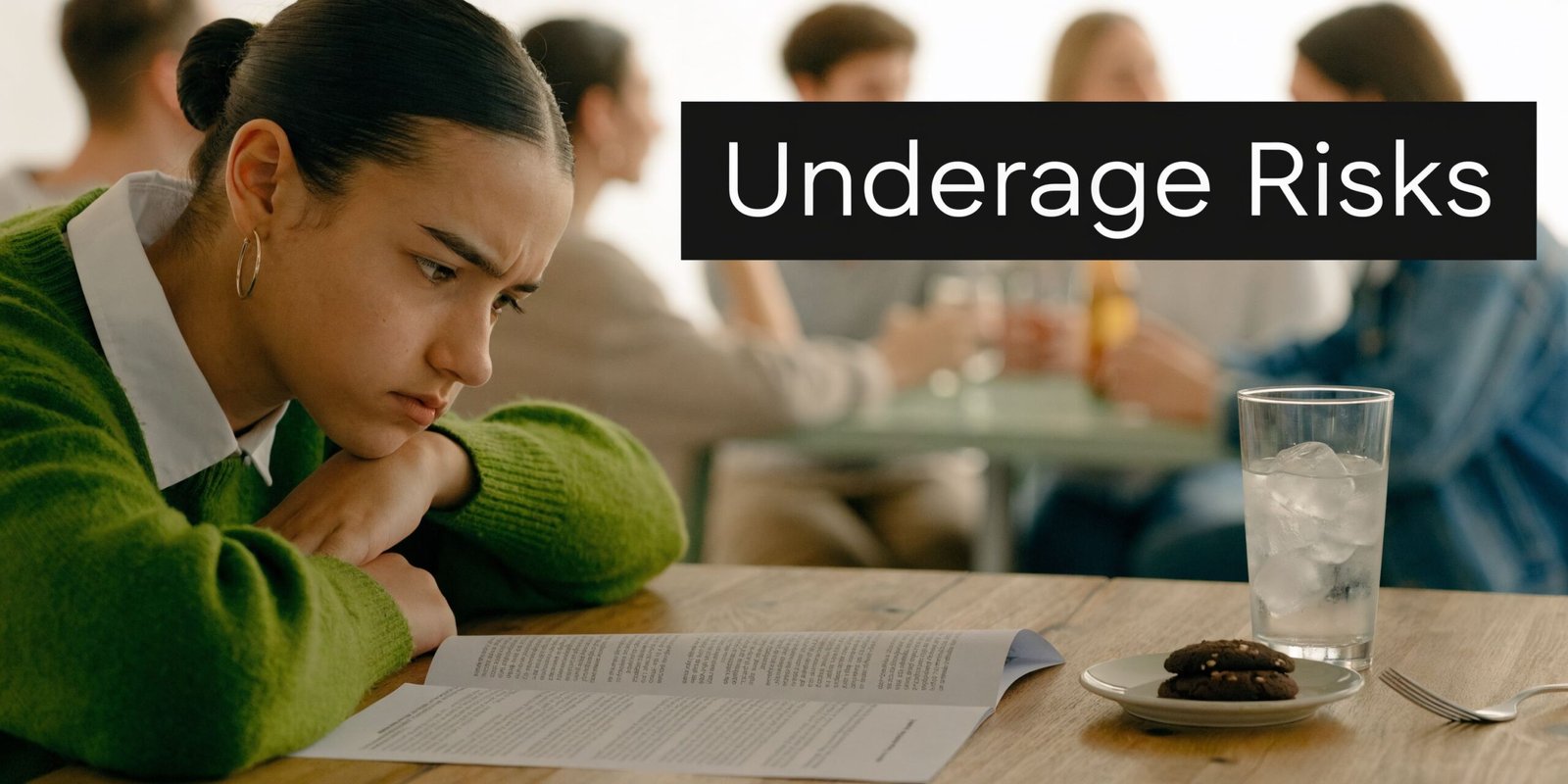 A teenage girl looking sad while reading a book in a social environment with people drinking.