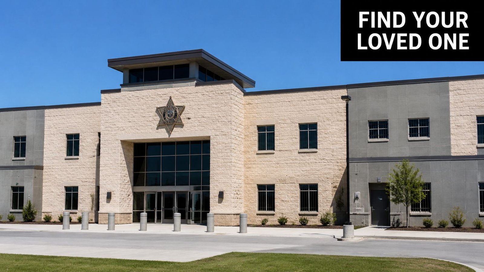 A modern detention facility building with stone brick exterior and a law enforcement star emblem.