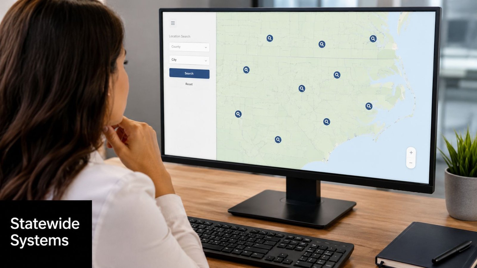 A professional woman using an inmate locator tool on her computer to search map locations.